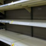 Grocery store with empty shelves for goods during the Coronavirus COVID-19 pandemic in a supermarket