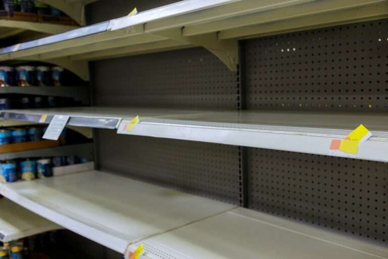 Grocery store with empty shelves for goods during the Coronavirus COVID-19 pandemic in a supermarket